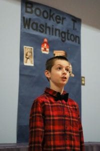 A Crawford ES student presents to peers about educator, author, and orator Booker T. Washington